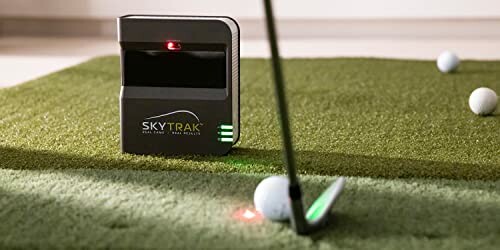 Golf launch monitor with golf balls on artificial turf