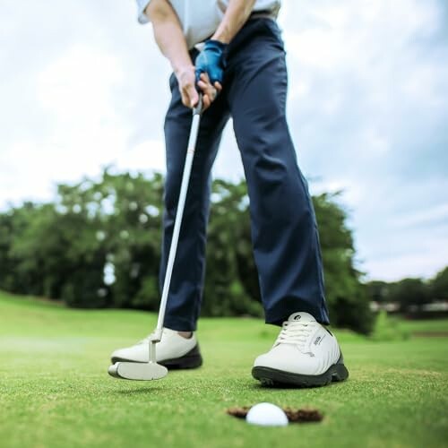 Golfer preparing to putt on a green