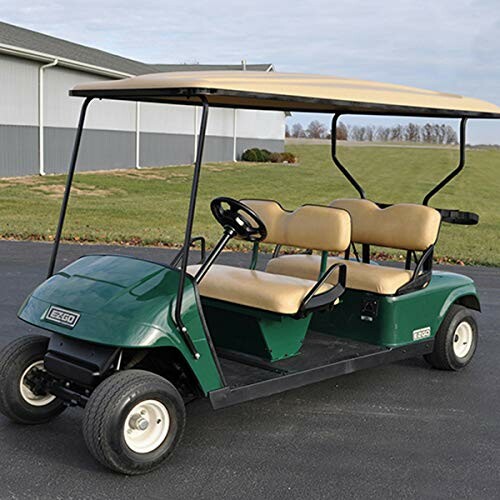 Green golf cart with beige seats on a driveway.