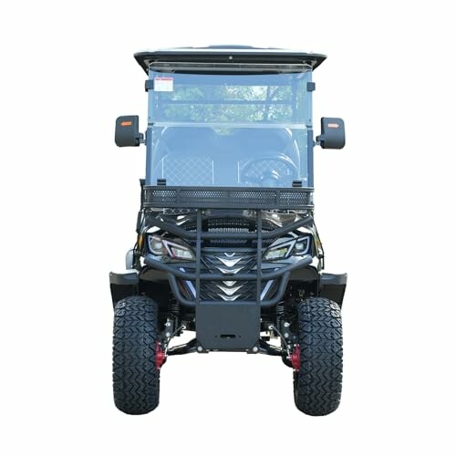 Front view of a utility vehicle with rugged tires and windshield.